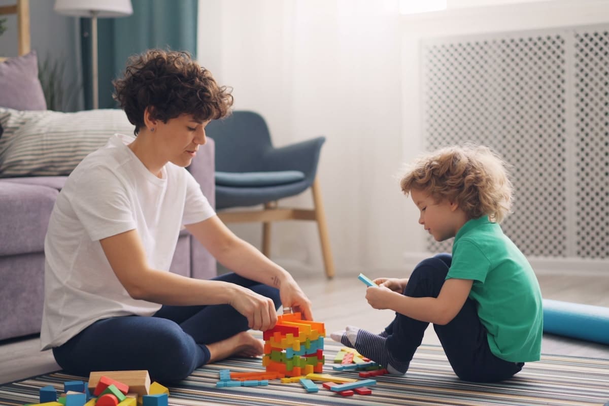 Therapist supporting a child during hands-on ABA service activities
